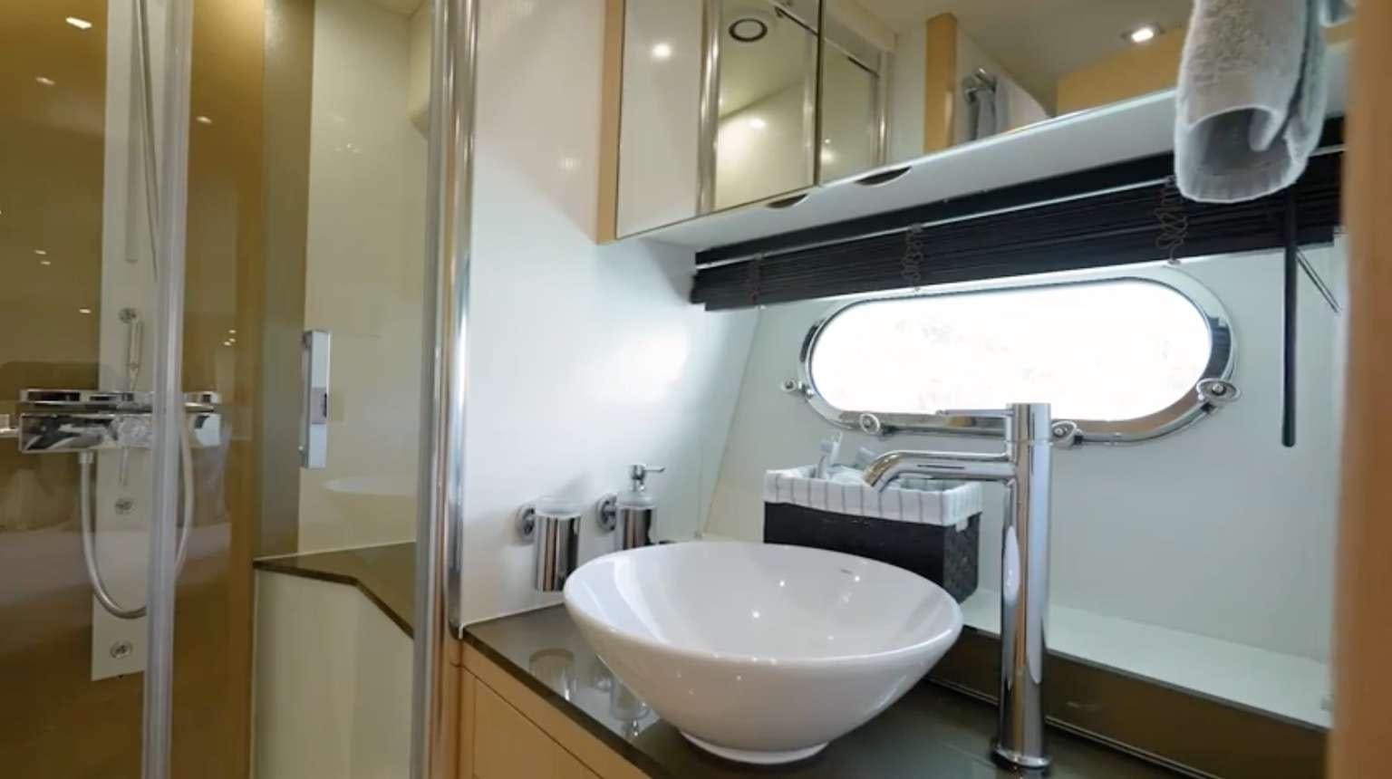 a bathroom with a sink and a large mirror aboard IT'S ENOUGH Yacht for Charter