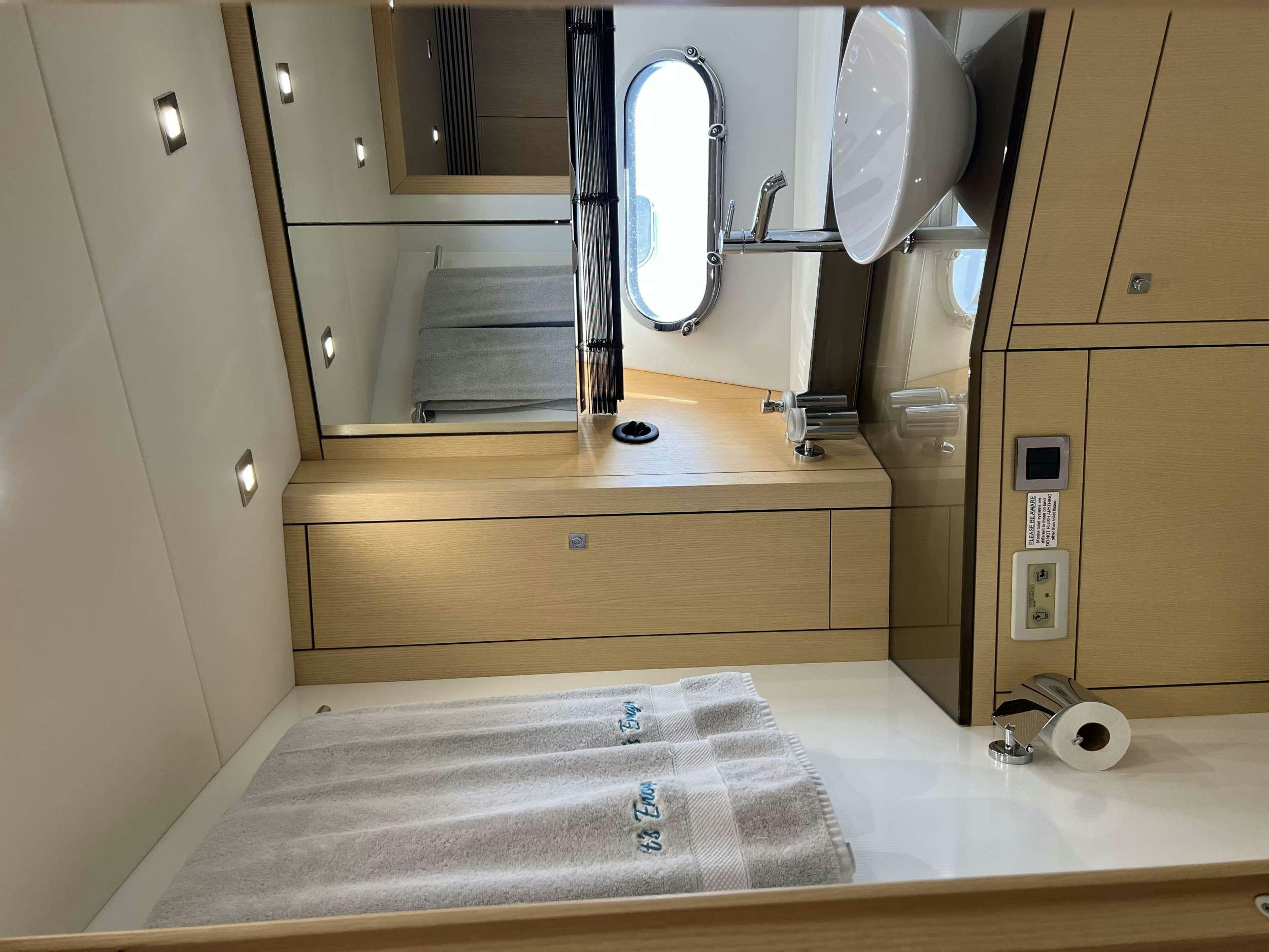 a bathroom with a mirror and a sink aboard IT'S ENOUGH Yacht for Charter