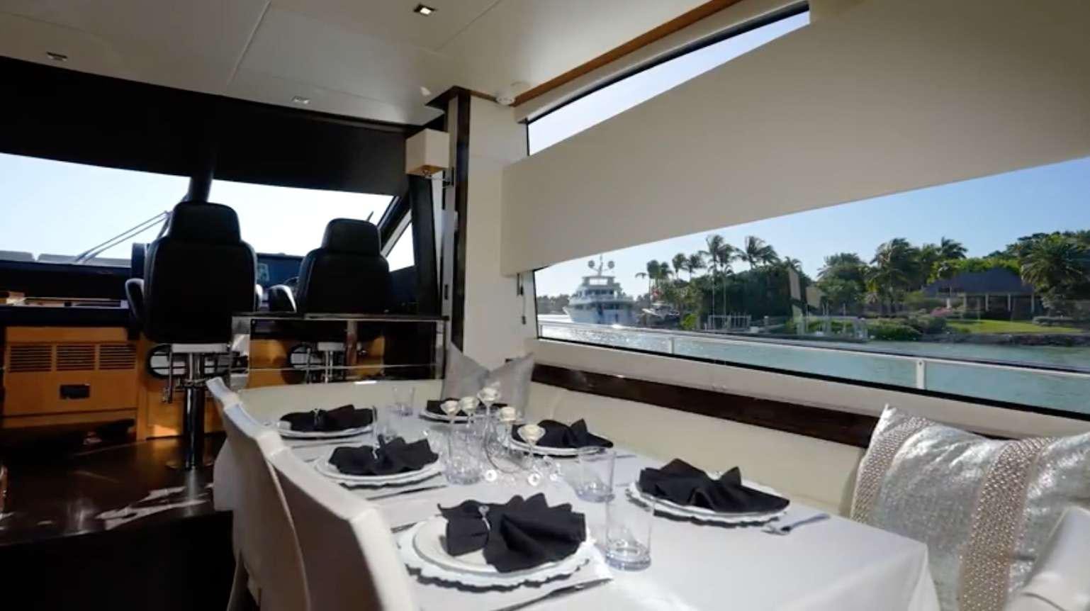 a table with plates and glasses on it aboard IT'S ENOUGH Yacht for Charter