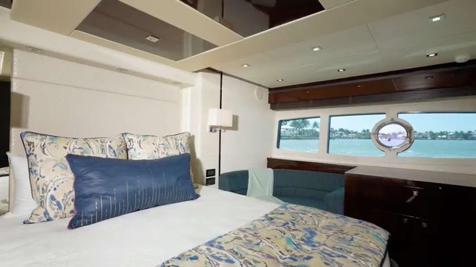 a room with a bed and a window aboard IT'S ENOUGH Yacht for Charter