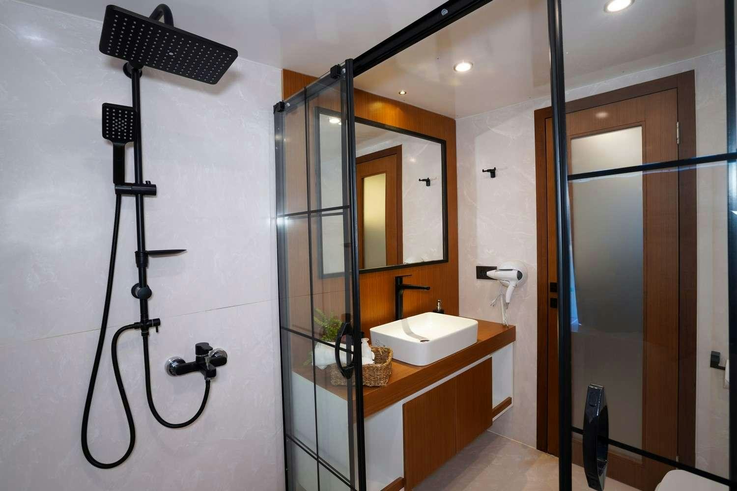 a bathroom with a sink and mirror aboard CINAR YILDIZI Yacht for Charter