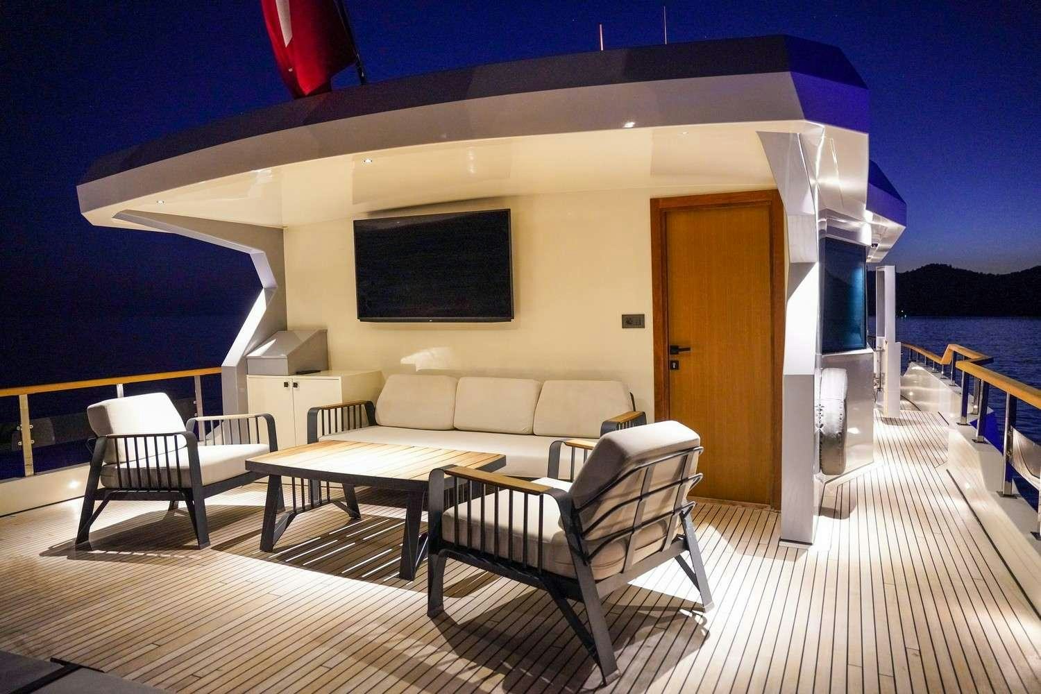 a room with a couch and a table and chairs aboard CINAR YILDIZI Yacht for Charter