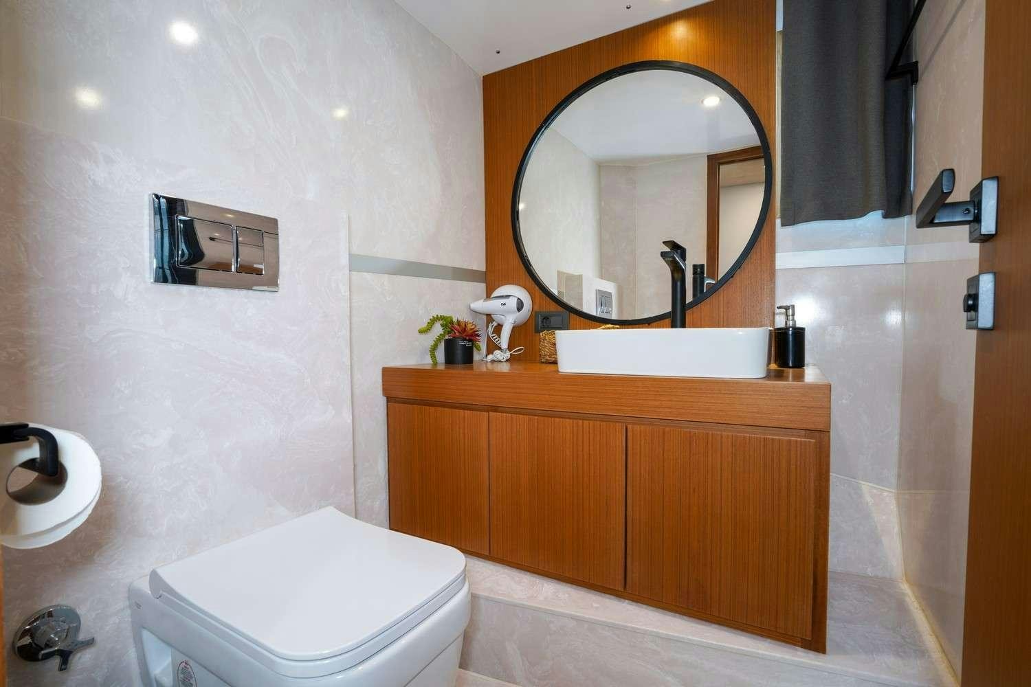 a bathroom with a toilet and a mirror aboard CINAR YILDIZI Yacht for Charter