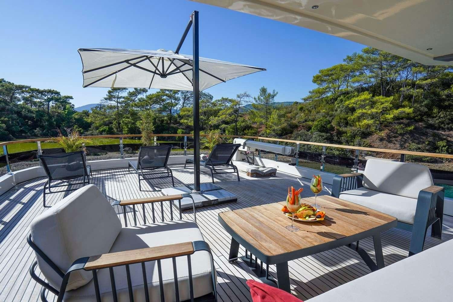 a patio with a table and chairs aboard CINAR YILDIZI Yacht for Charter