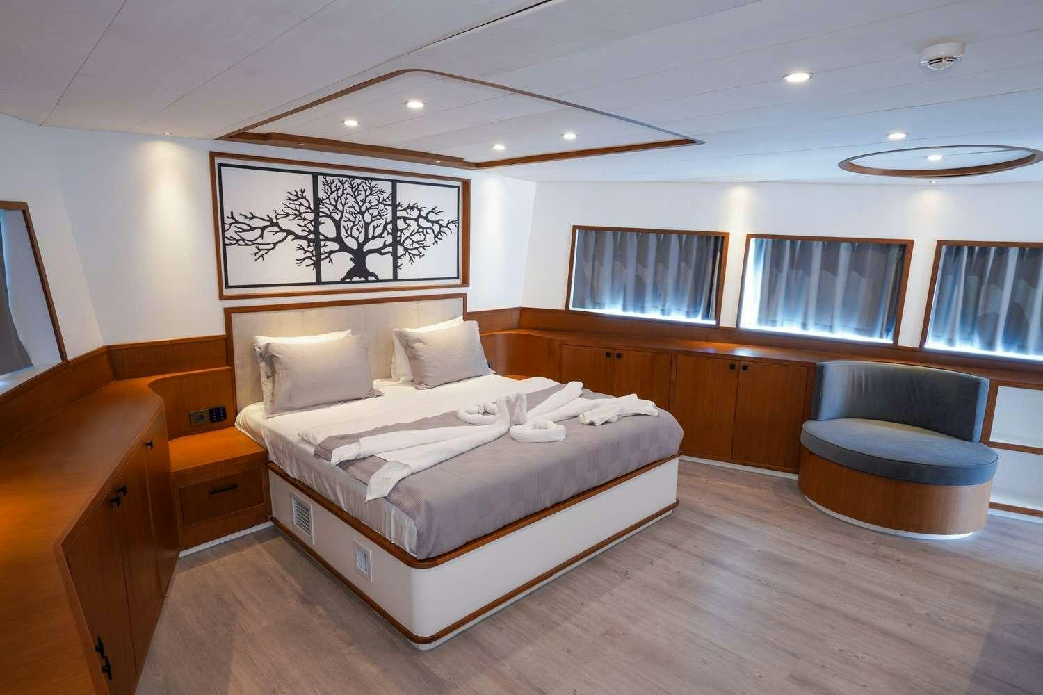 a large bedroom with a large bed aboard CINAR YILDIZI Yacht for Charter
