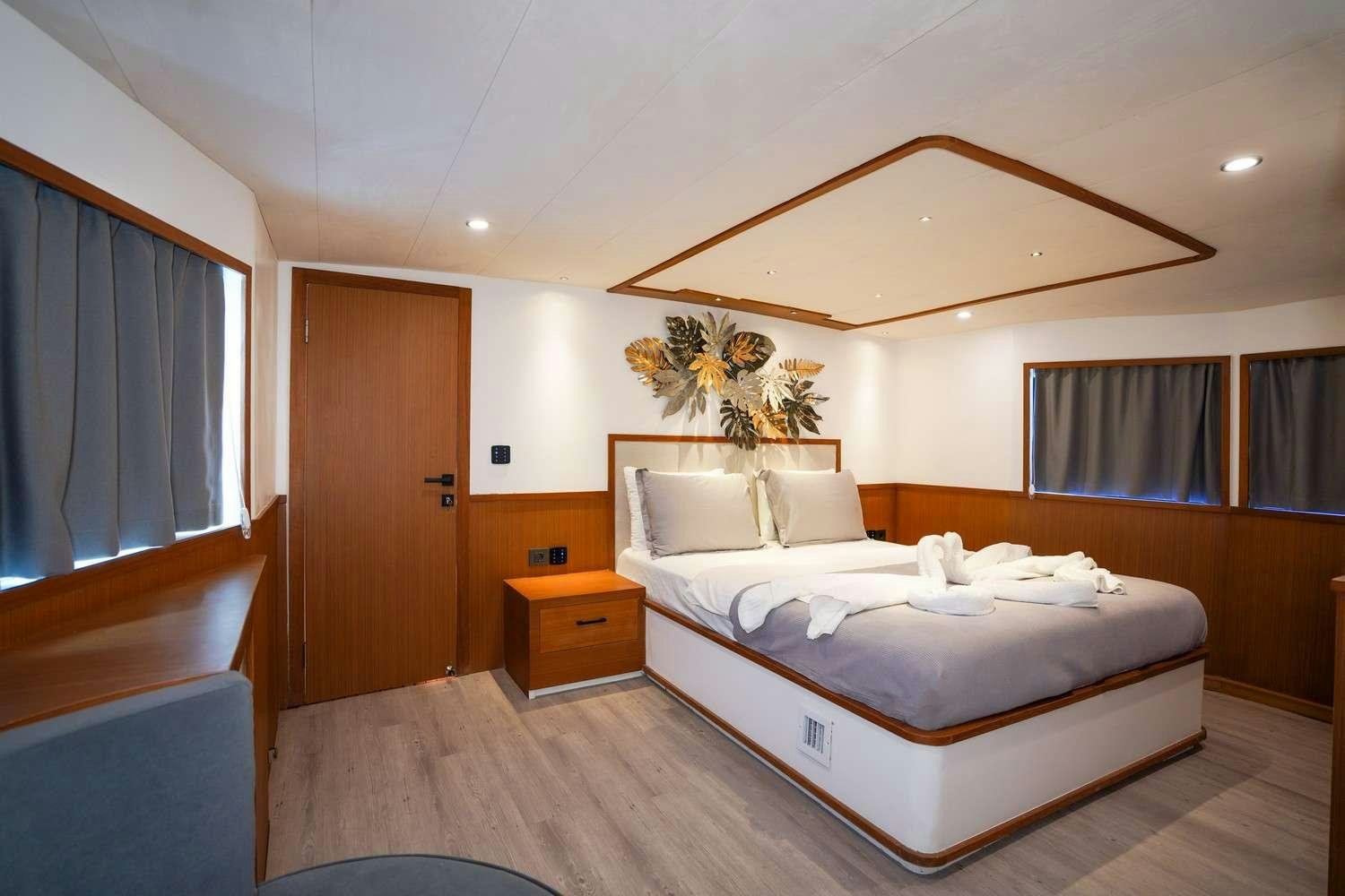 a bedroom with two beds aboard CINAR YILDIZI Yacht for Charter