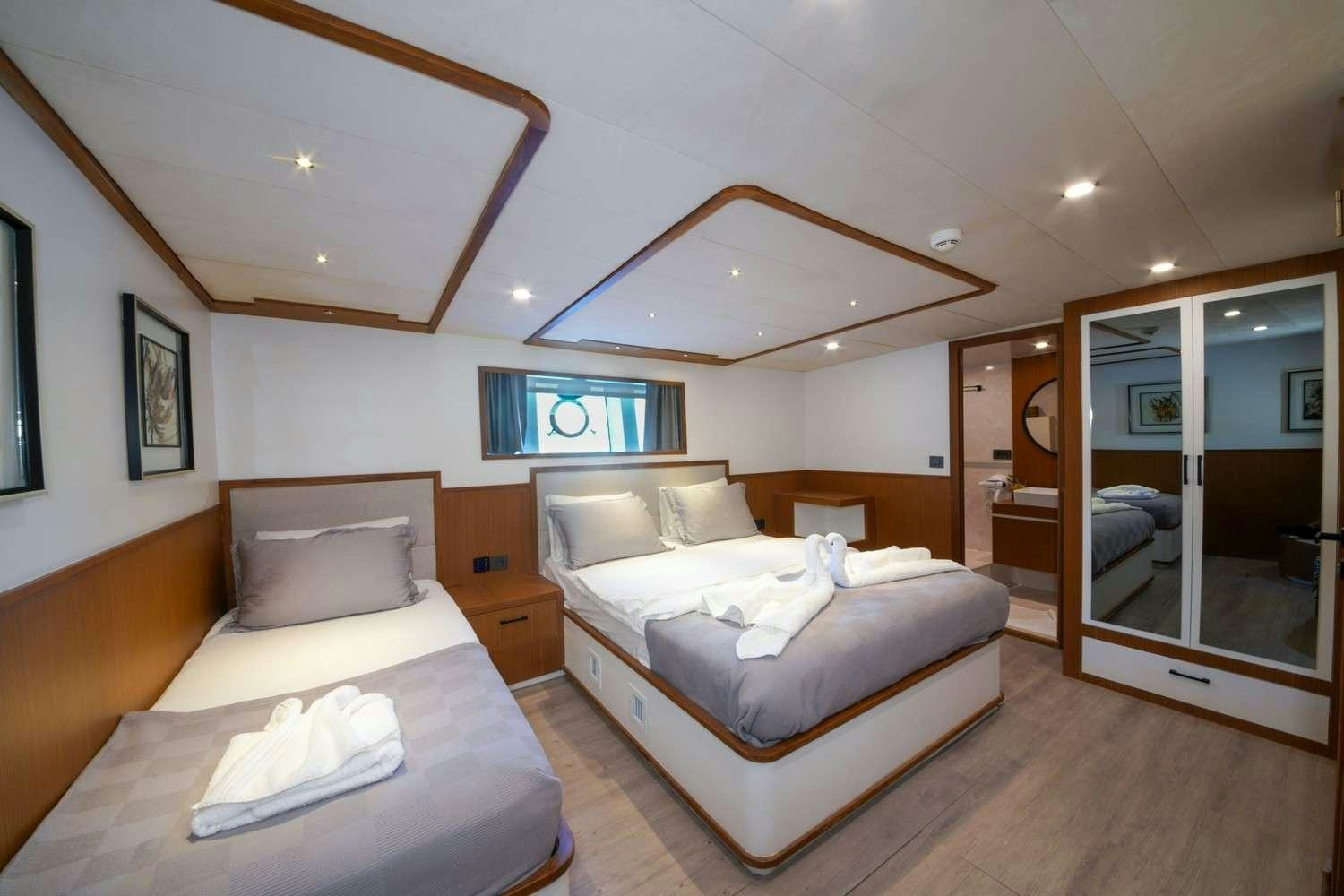 a room with two beds aboard CINAR YILDIZI Yacht for Charter