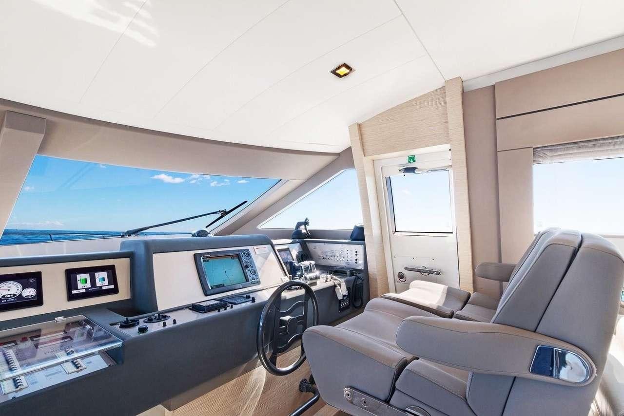 a room with a large screen and a couch and a television aboard LINDY LOU Yacht for Charter