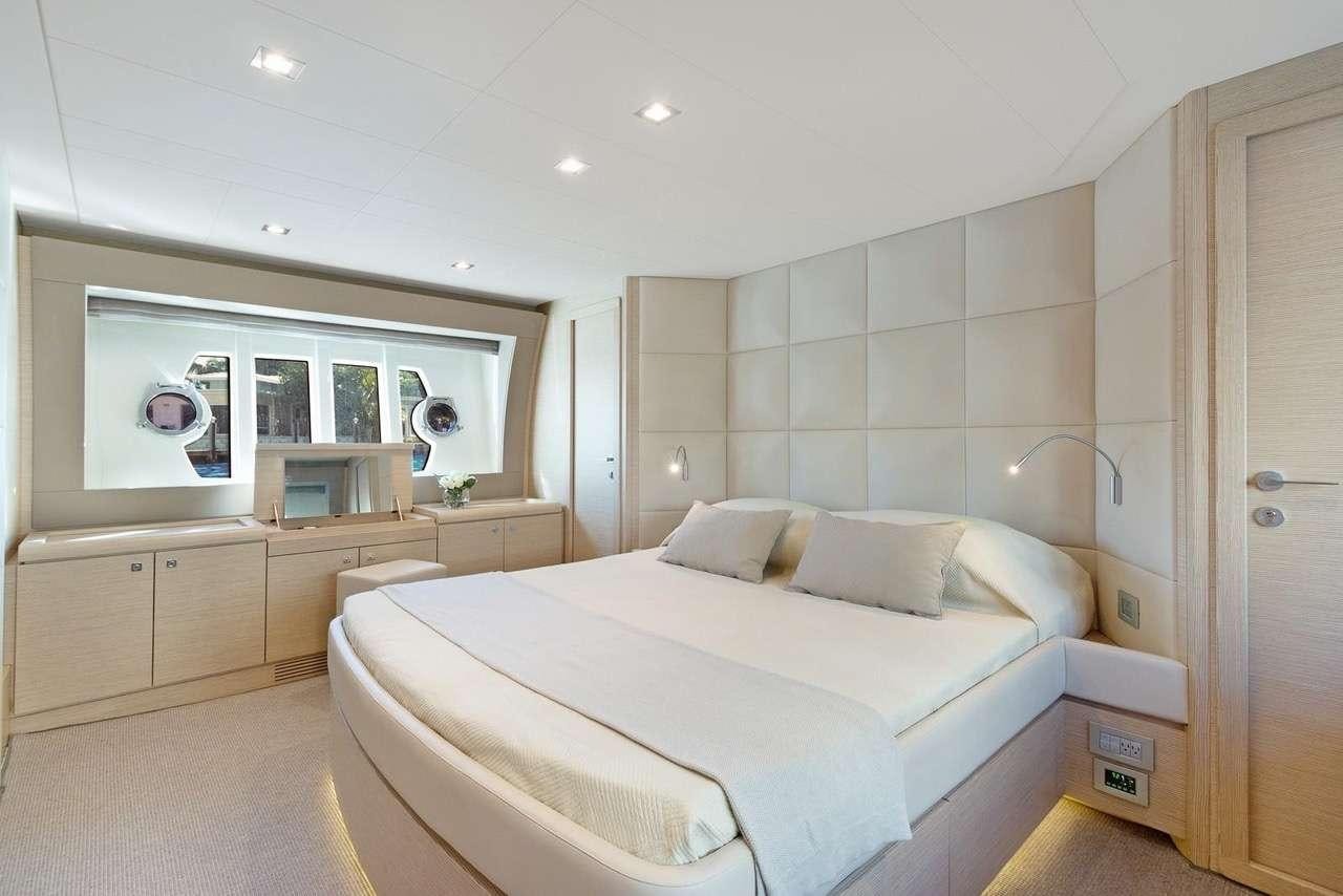 a bedroom with a bed and a desk aboard LINDY LOU Yacht for Charter