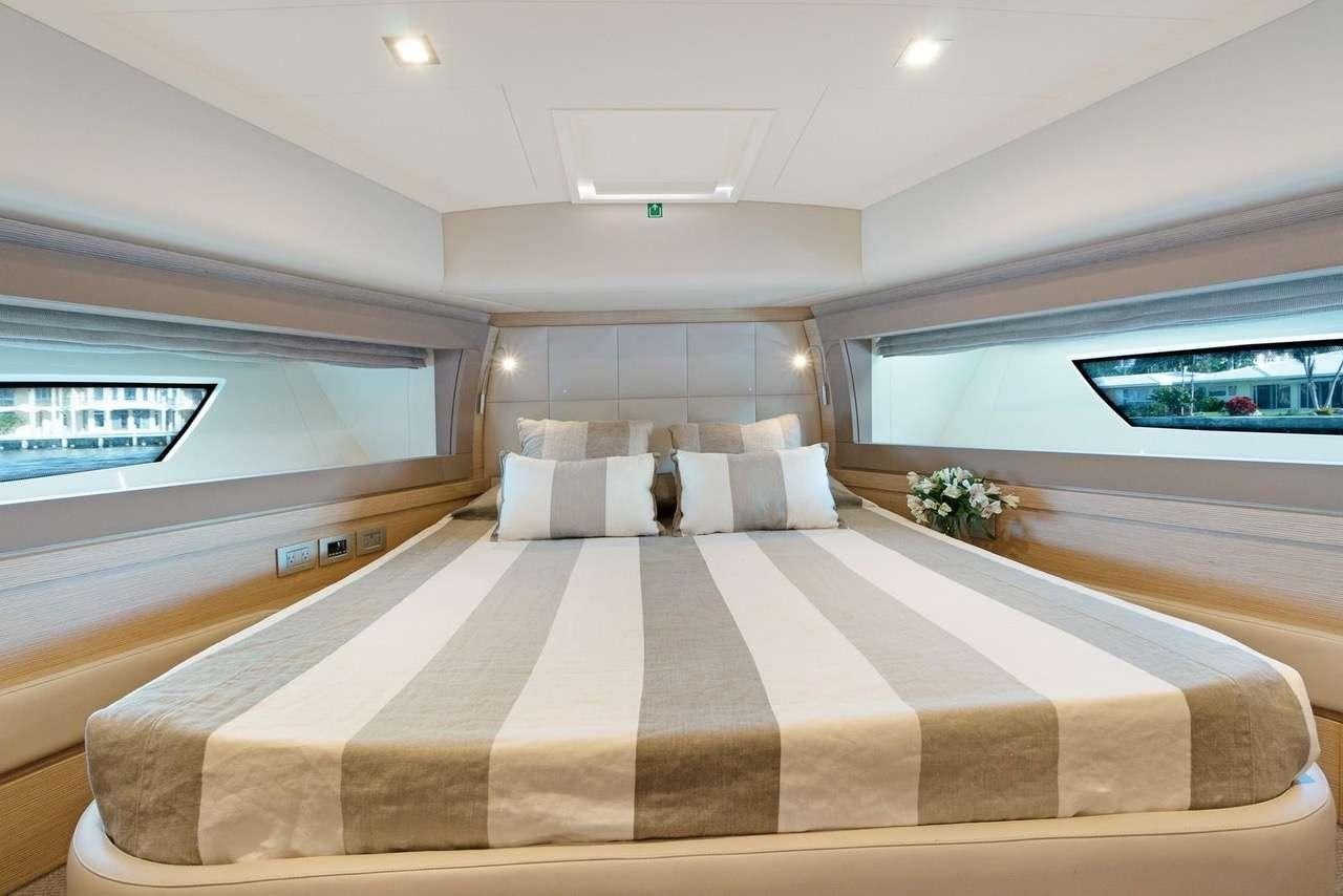a bed with a flowered bed aboard LINDY LOU Yacht for Charter