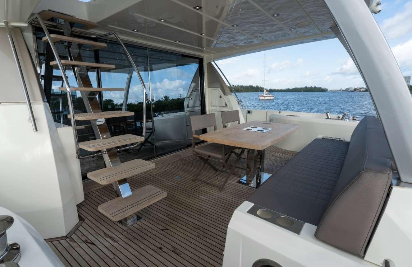 a room with a couch and a table and chairs aboard VIMA Yacht for Charter