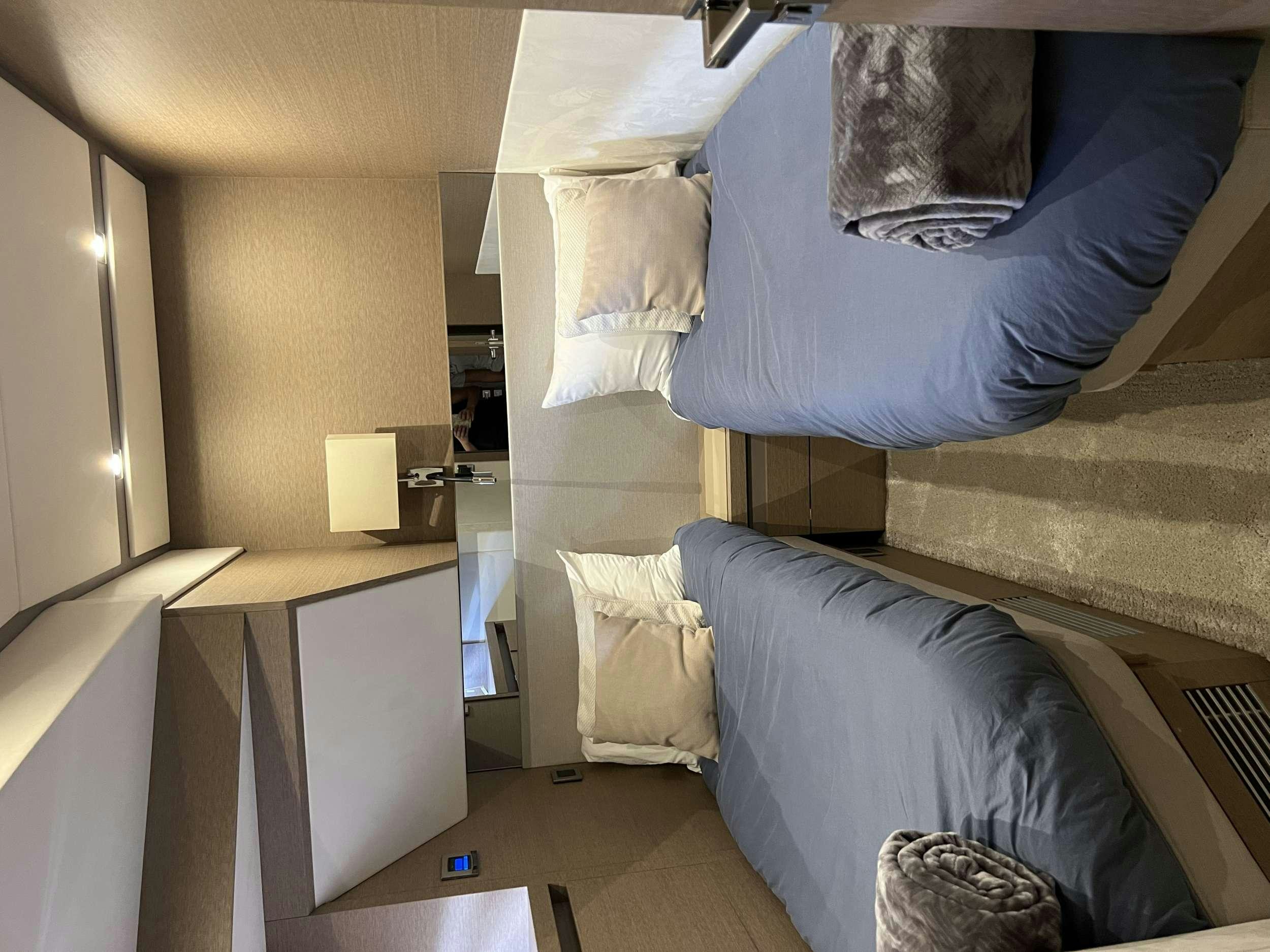 a room with a bed and a desk aboard VIMA Yacht for Charter