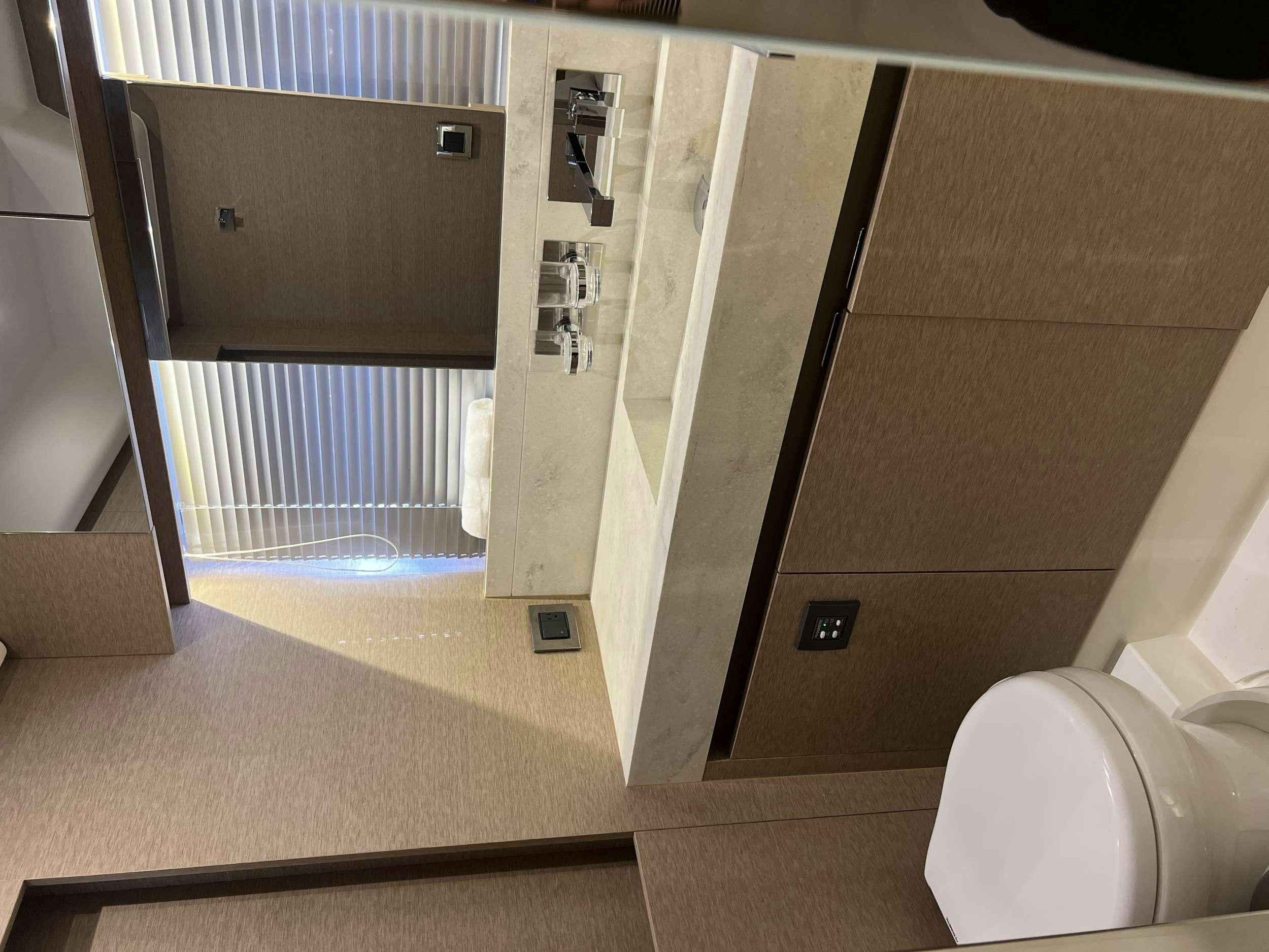 a bathroom with a glass shower aboard VIMA Yacht for Charter