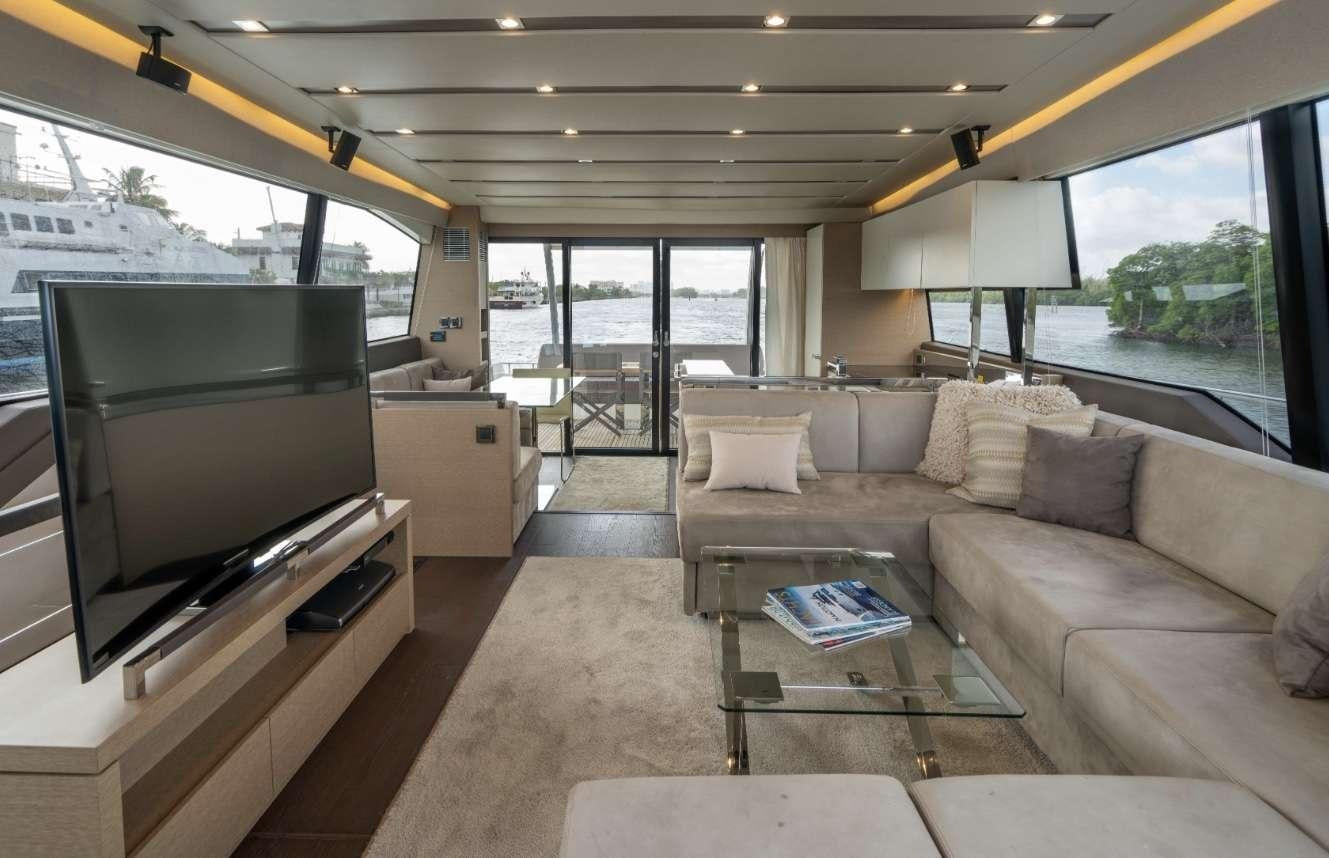 a living room with a couch and a tv aboard VIMA Yacht for Charter