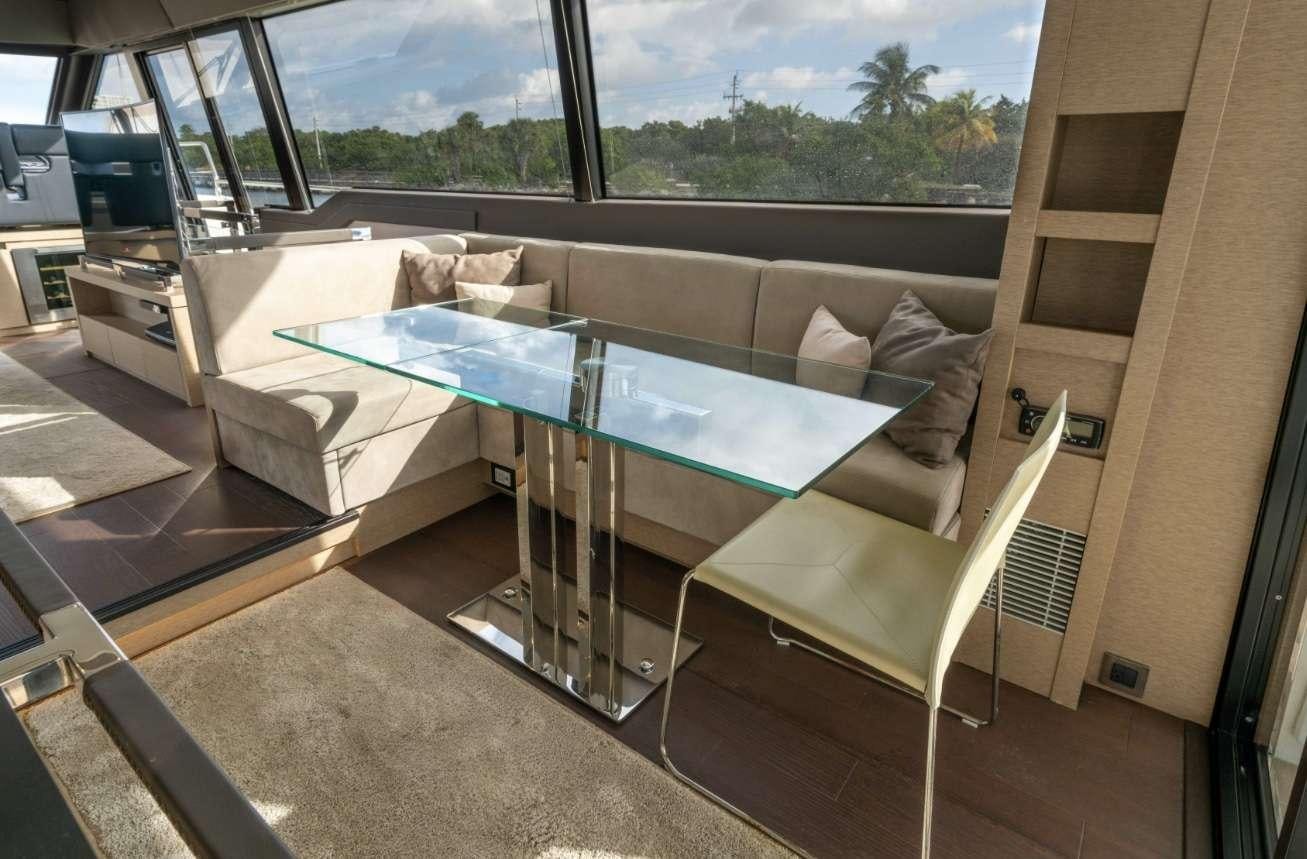 a large living room with a large glass window aboard VIMA Yacht for Charter