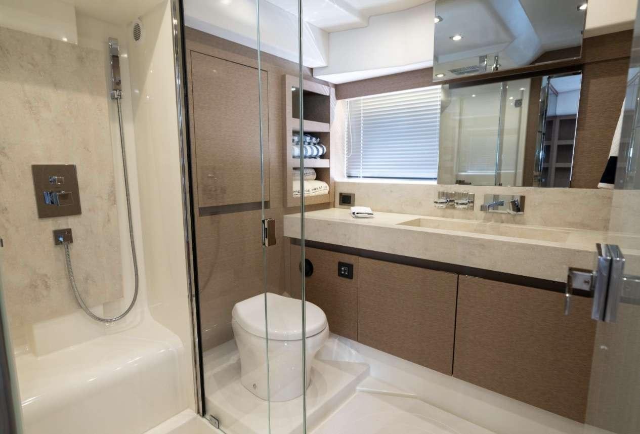 a bathroom with a toilet and a bathtub aboard VIMA Yacht for Charter