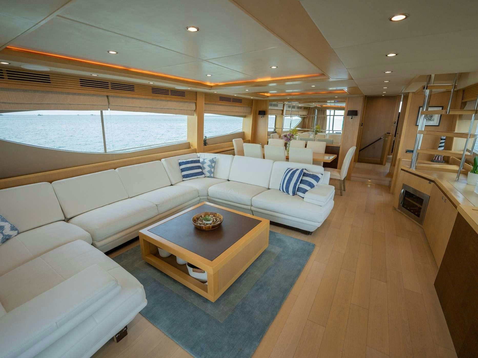 a living room with a large window aboard NO CURFEW Yacht for Charter