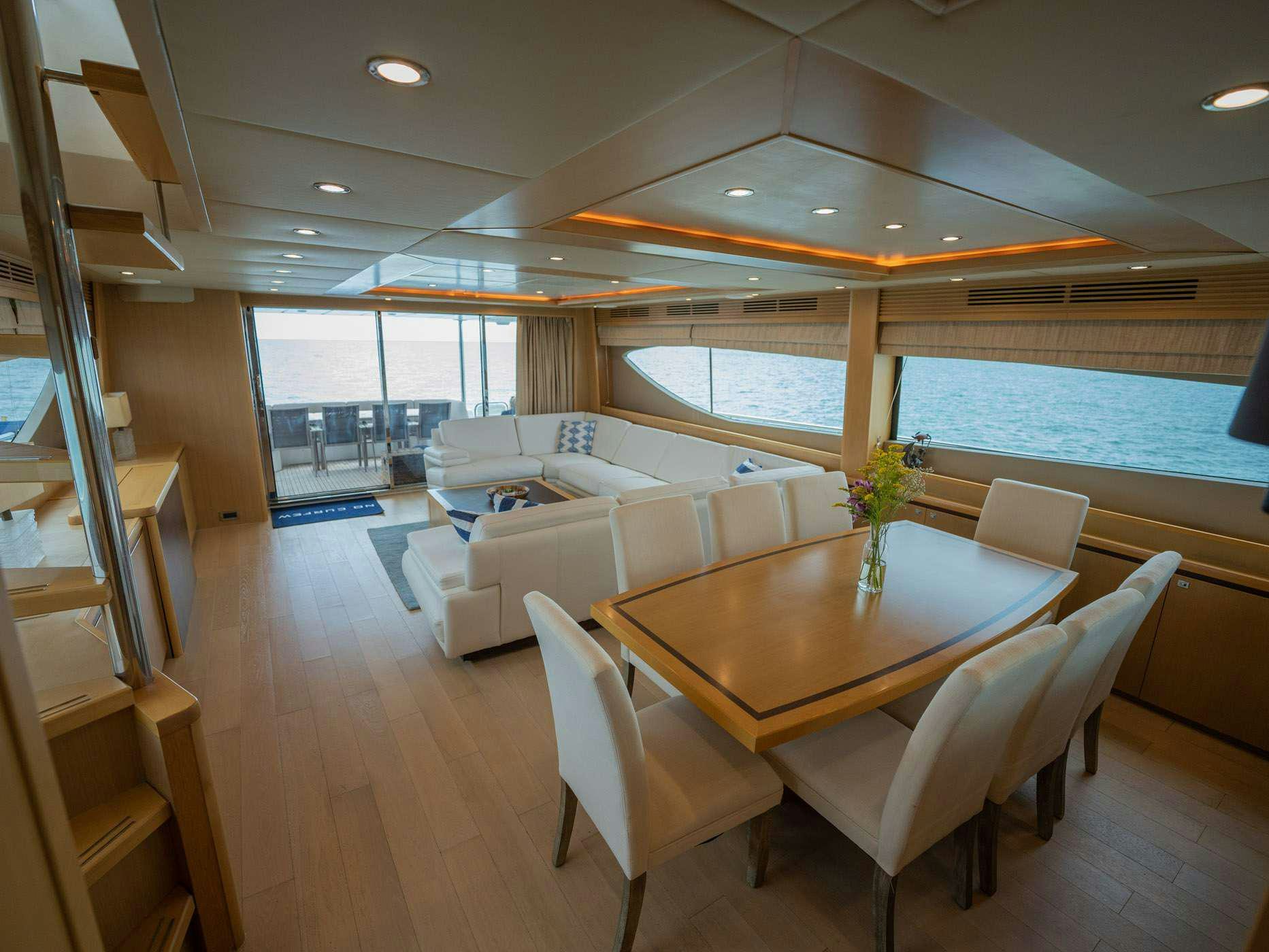a living room with a table and chairs aboard NO CURFEW Yacht for Charter