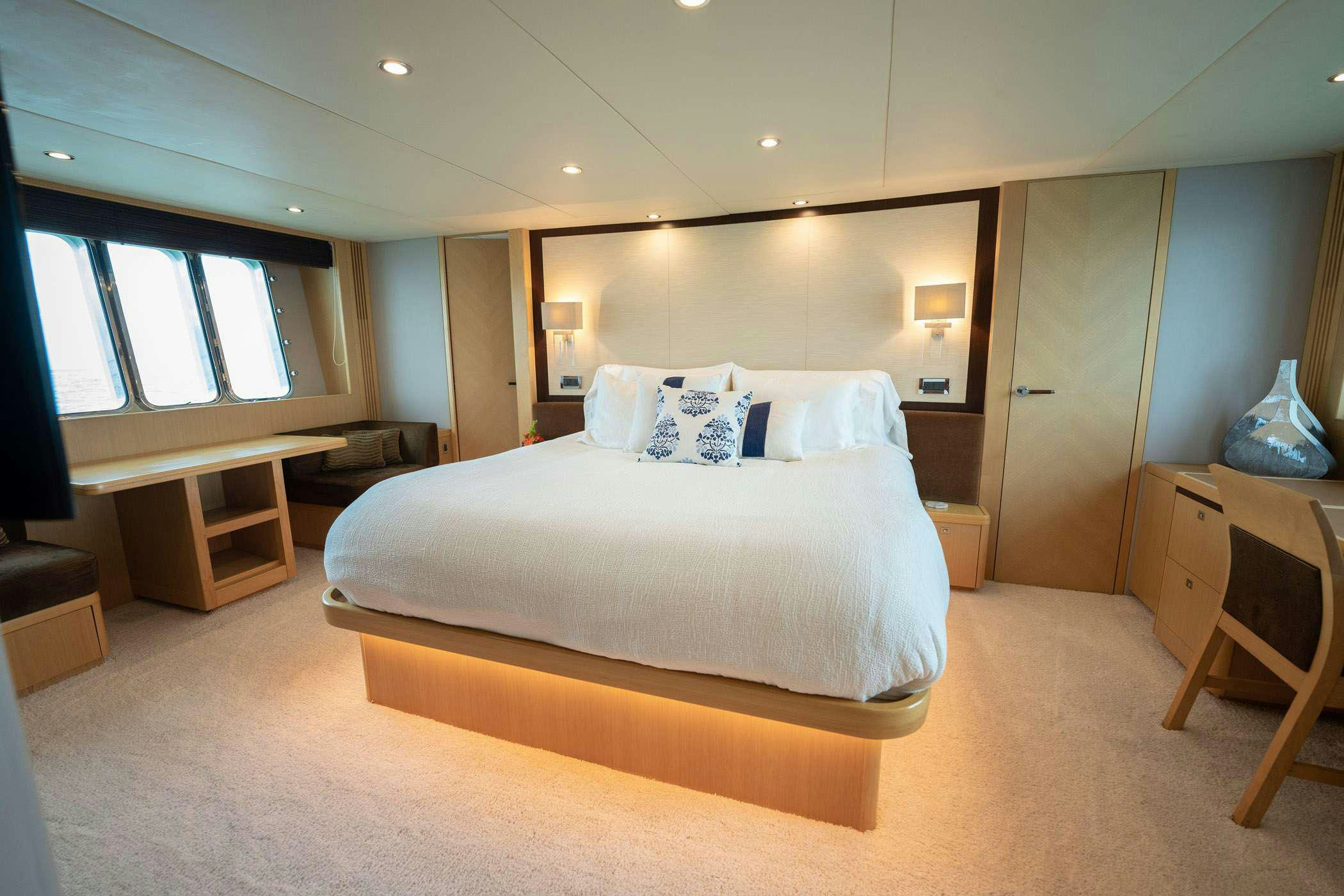 a large bedroom with a large bed aboard NO CURFEW Yacht for Charter