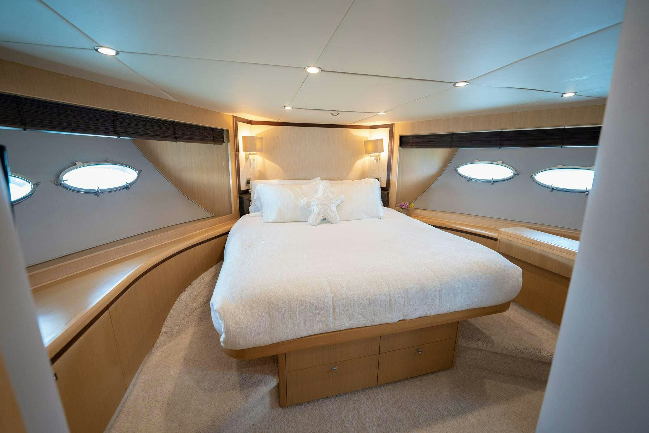 a bed in a room aboard NO CURFEW Yacht for Charter