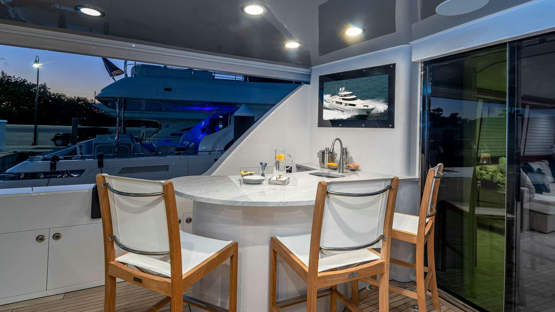 a table with chairs on it aboard NO SHORTCUTS Yacht for Charter