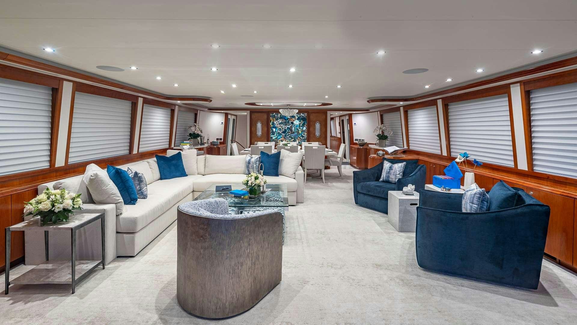 a living room with a couch and a table aboard NO SHORTCUTS Yacht for Charter