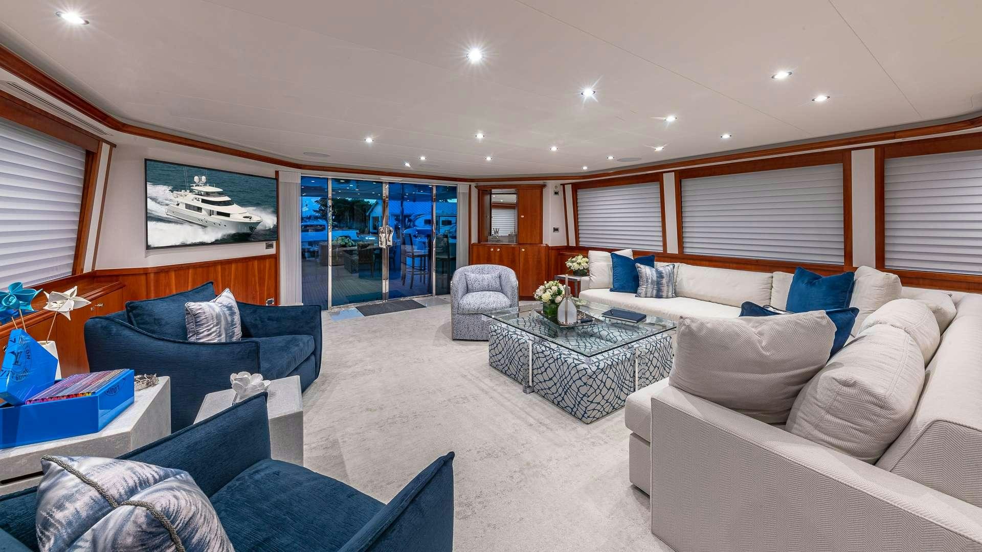 a living room with a couch and a table aboard NO SHORTCUTS Yacht for Charter