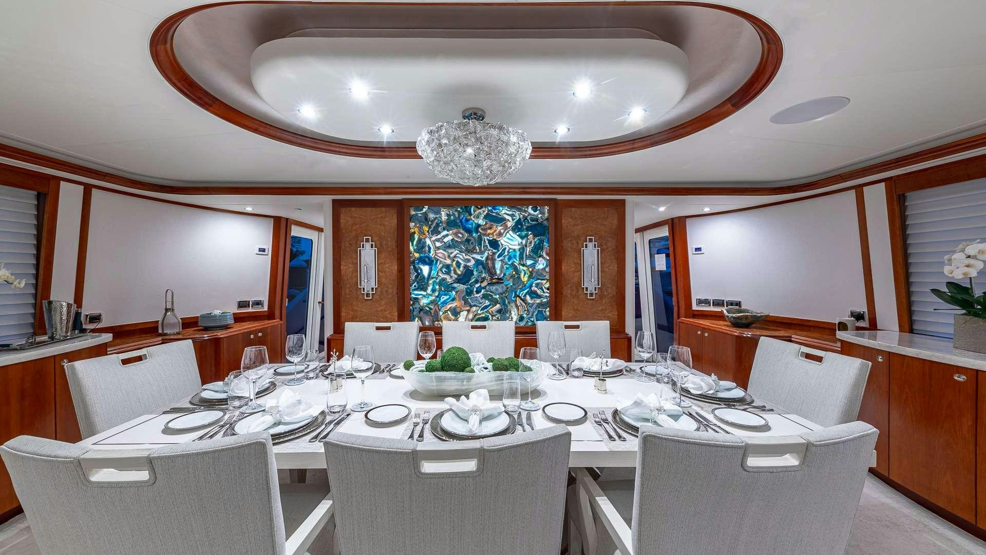 a large dining room with a large table and chairs aboard NO SHORTCUTS Yacht for Charter