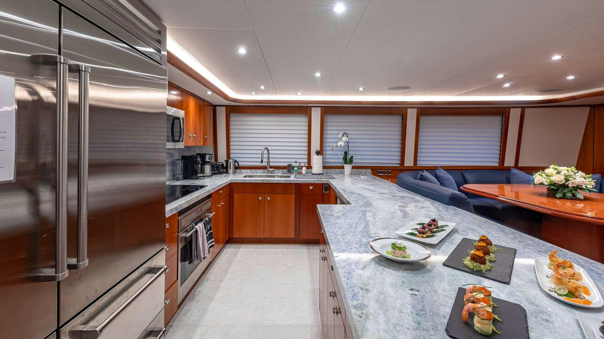 a kitchen with a large refrigerator aboard NO SHORTCUTS Yacht for Charter