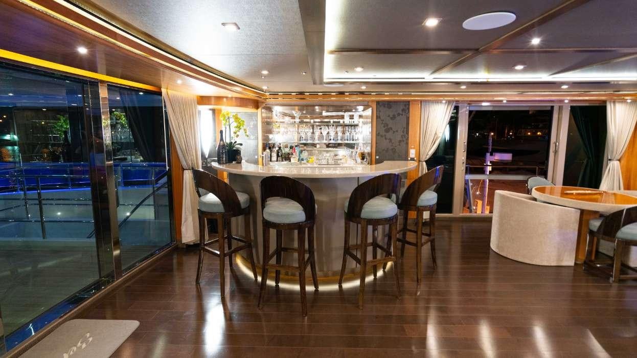 a restaurant with tables and chairs aboard SERENITY Yacht for Charter