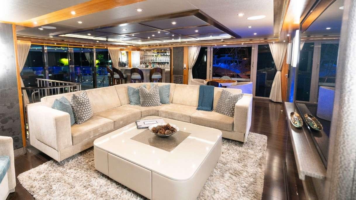 a living room with a couch and a table aboard SERENITY Yacht for Charter
