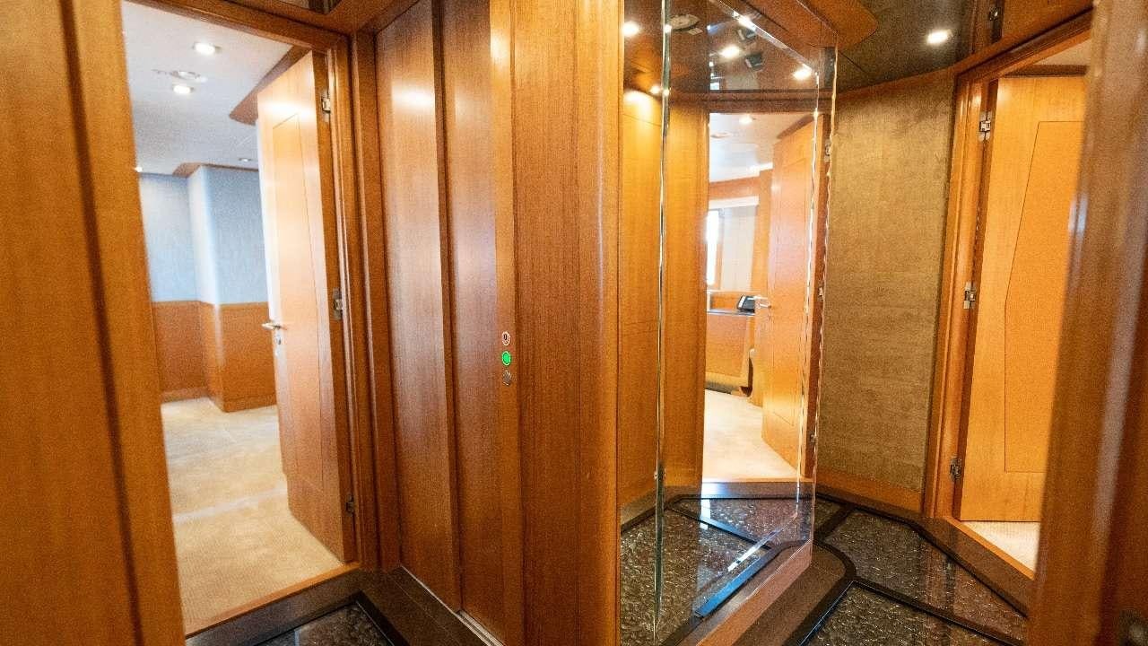 a hallway with a glass door aboard SERENITY Yacht for Charter