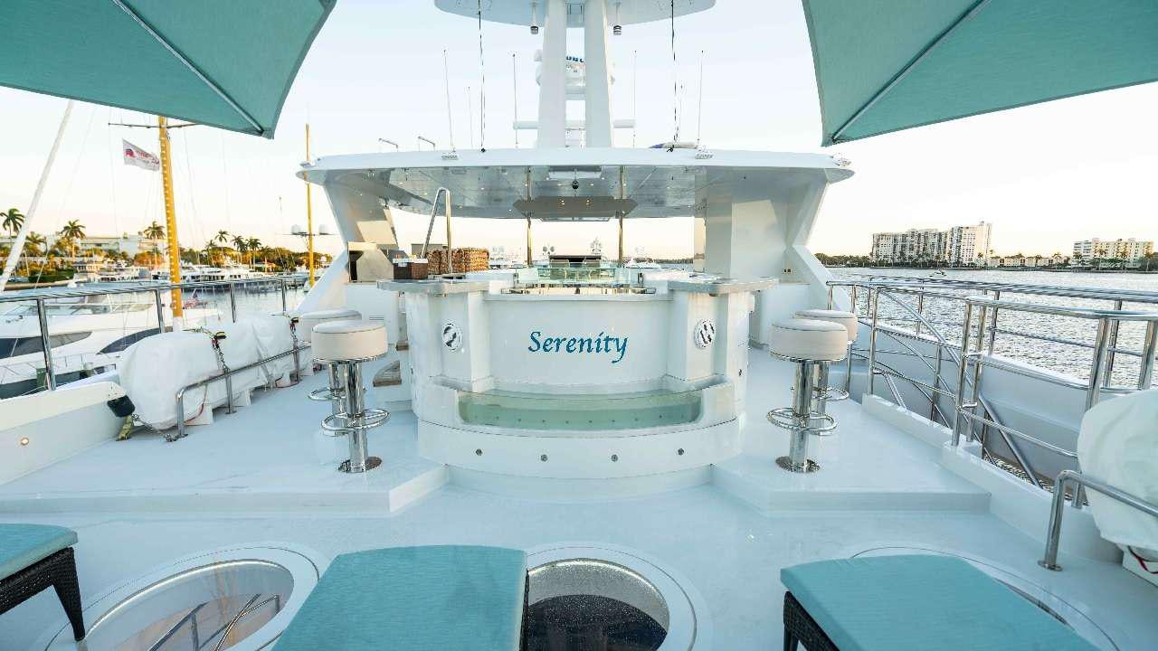 a large white boat on a body of water aboard SERENITY Yacht for Charter