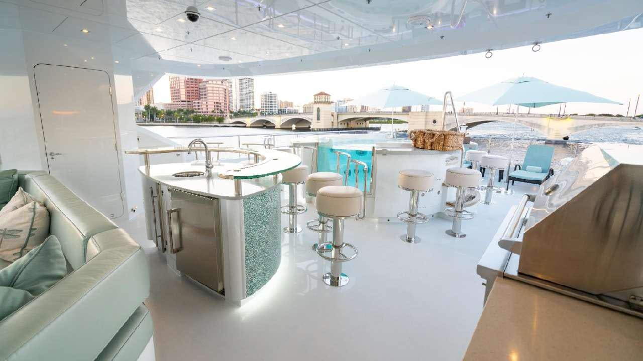 a room with a table chairs and a large window aboard SERENITY Yacht for Charter