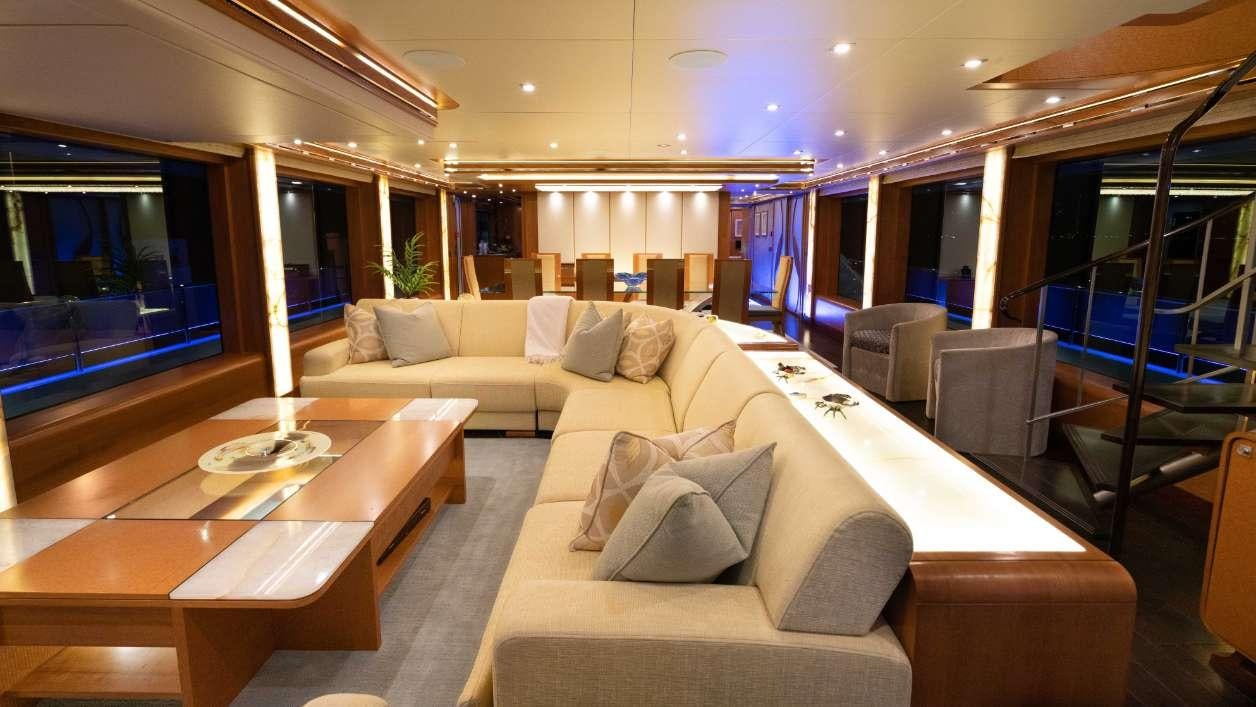 a living room with a couch and a table aboard SERENITY Yacht for Charter