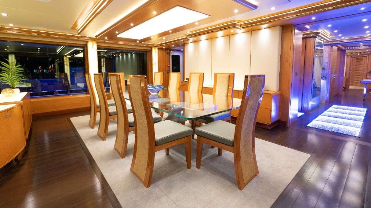 a room with chairs and tables aboard SERENITY Yacht for Charter