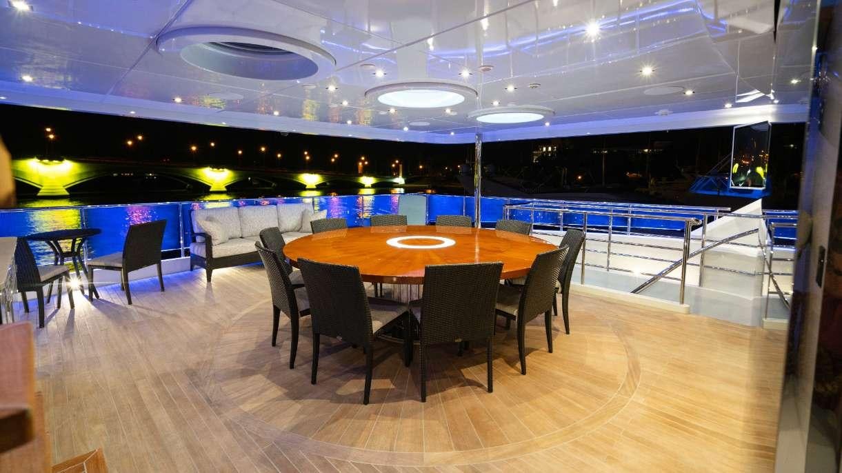 a room with a table and chairs aboard SERENITY Yacht for Charter