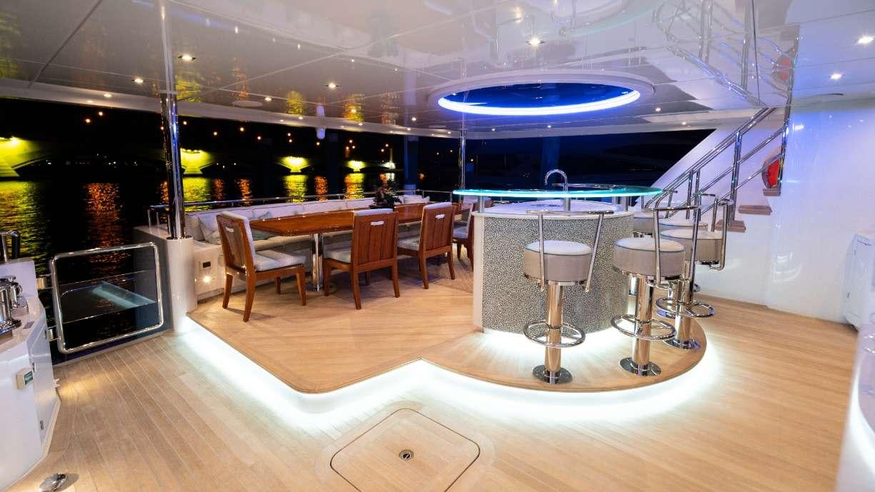 a room with tables and chairs aboard SERENITY Yacht for Charter