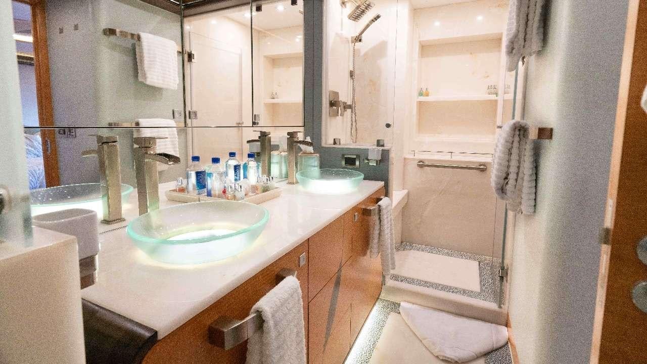 a bathroom with a sink and a mirror aboard SERENITY Yacht for Charter