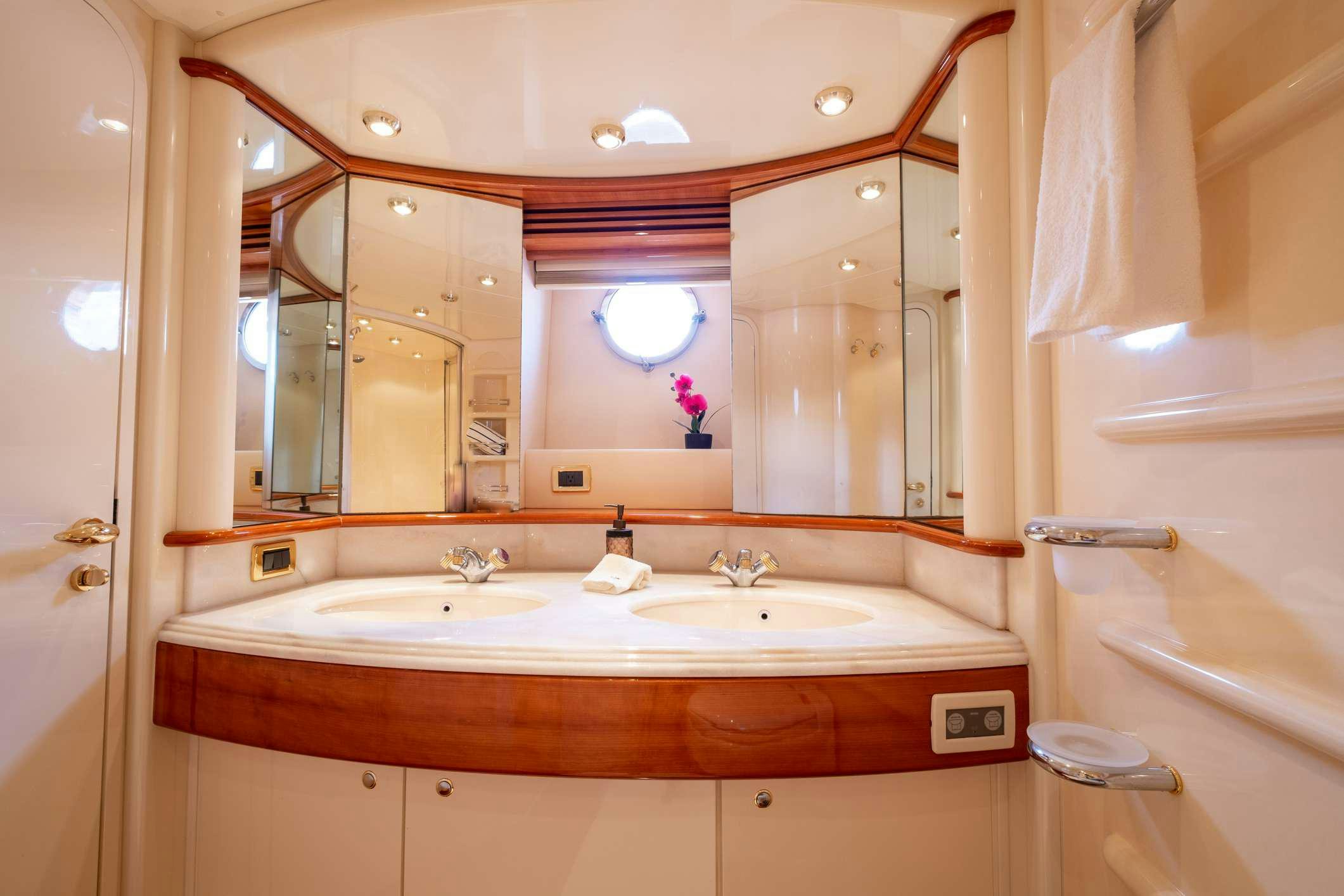 a bathroom with a large mirror aboard VICTORIA Yacht for Charter
