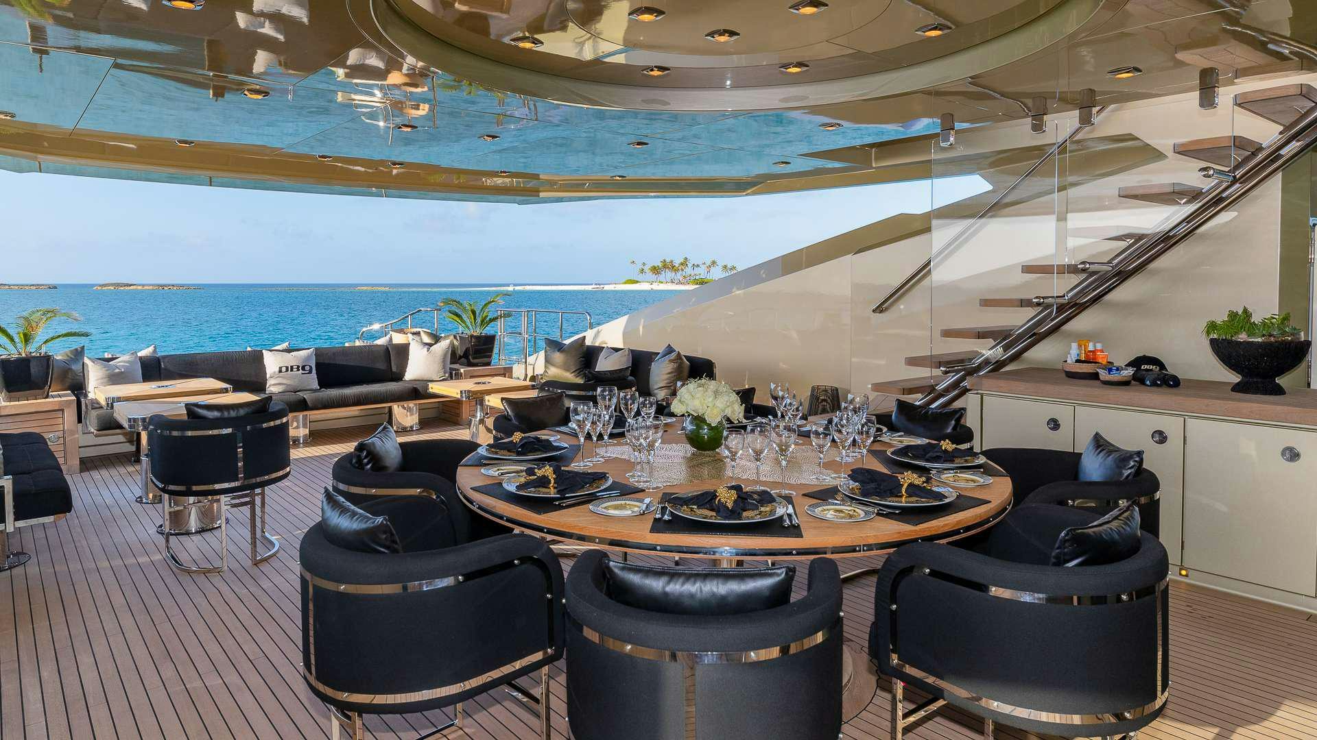 a room with a table chairs and a large window aboard DB9 Yacht for Charter