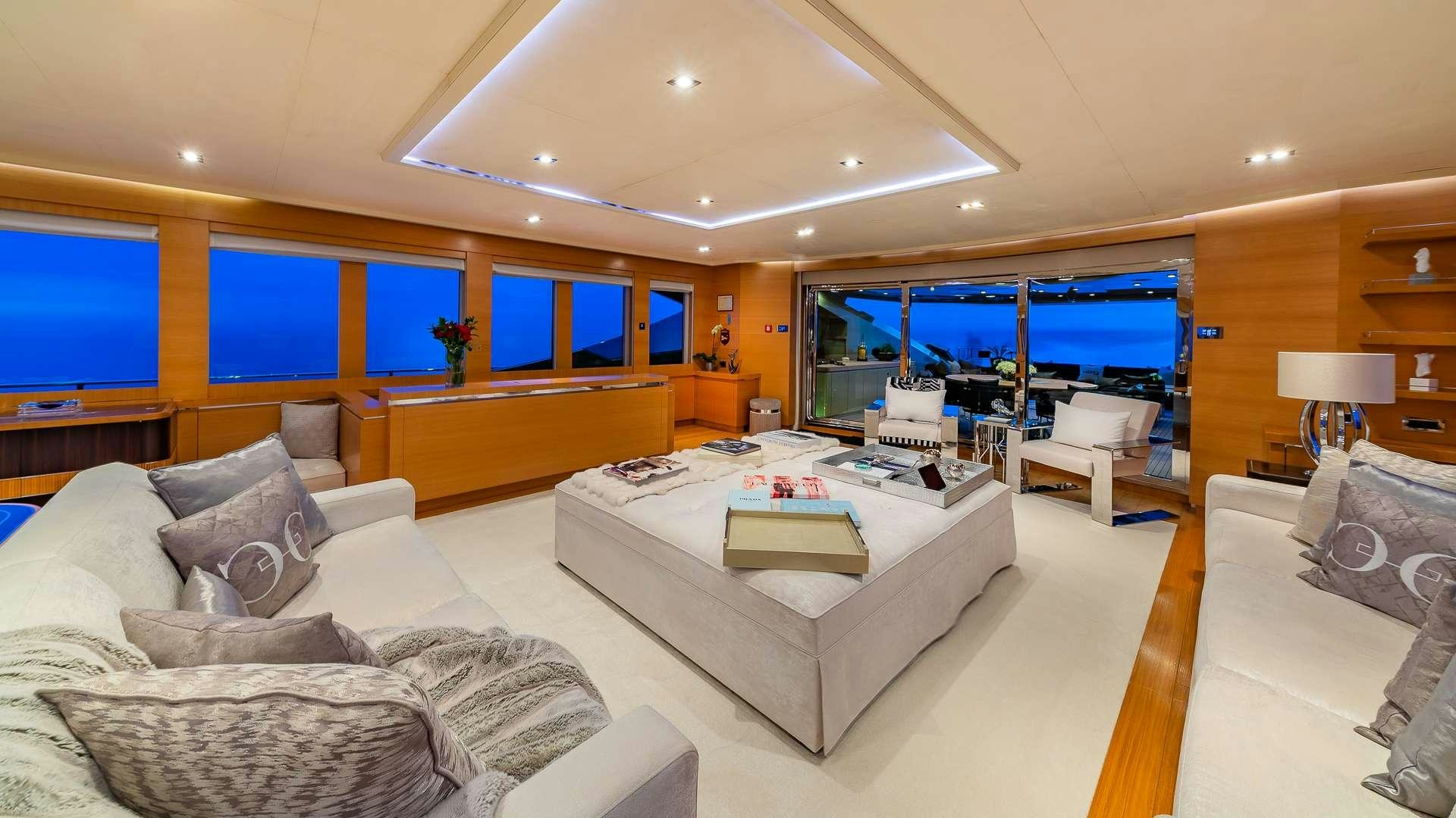 a large living room with a large white bed and a large window aboard DB9 Yacht for Charter