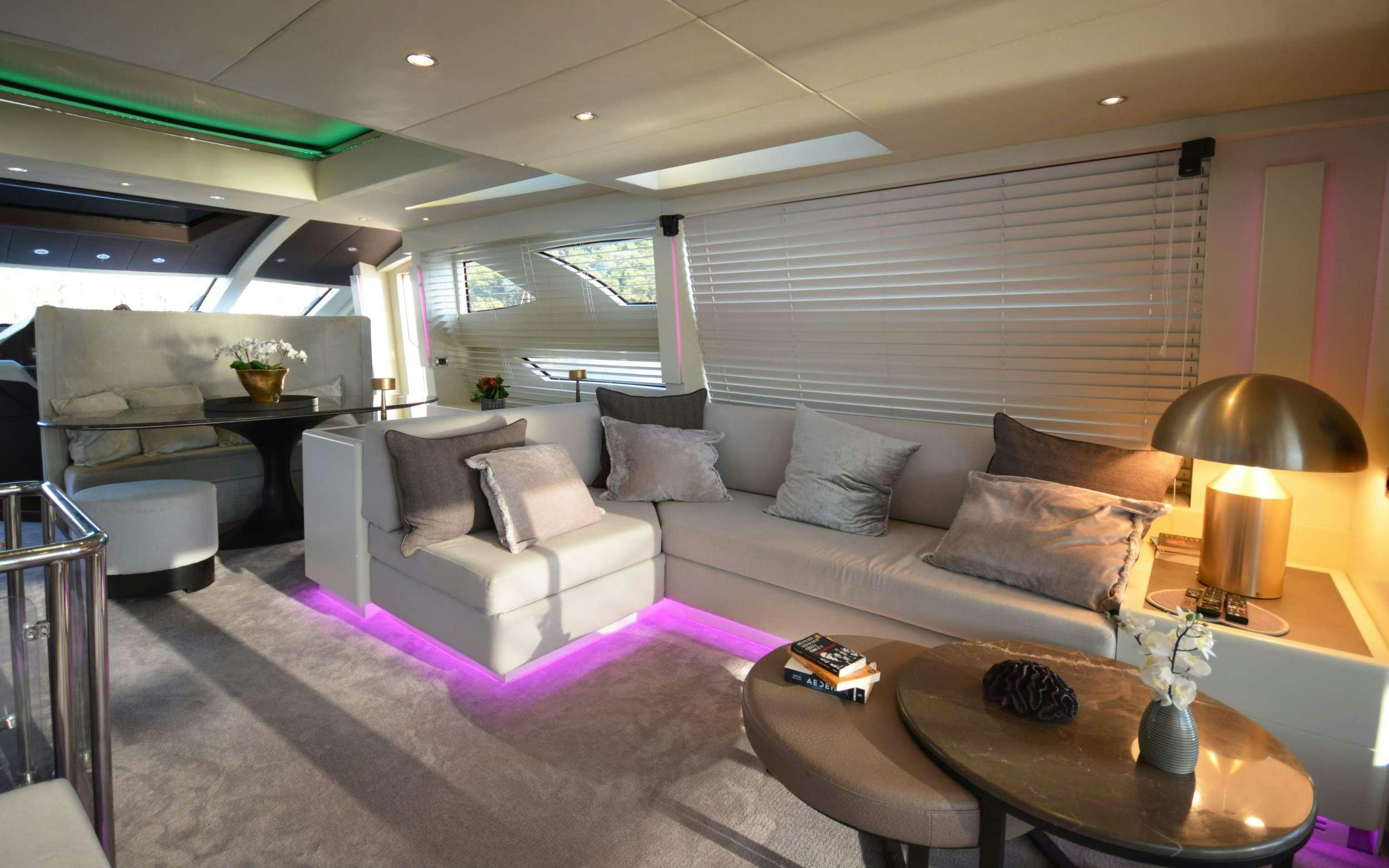a living room with a couch and a table aboard GOLDFINGER Yacht for Charter