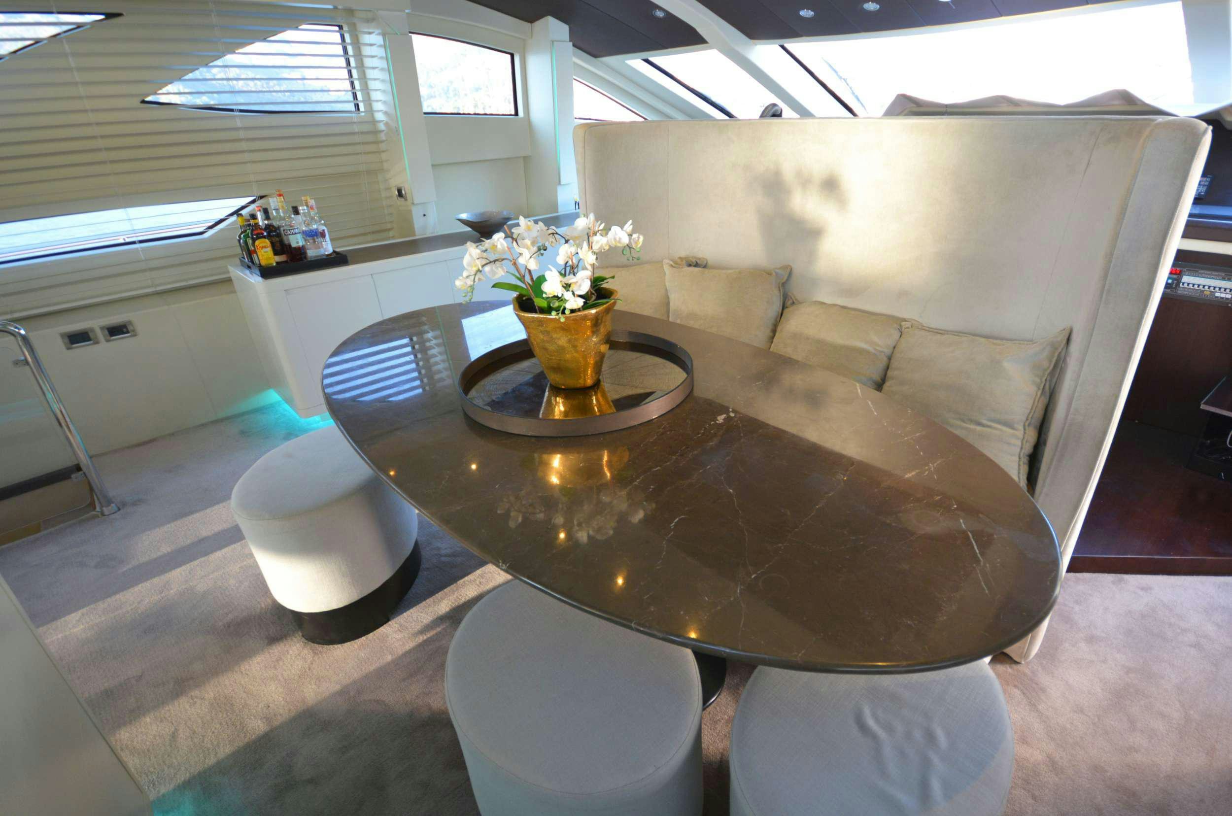 a room with a table and chairs aboard GOLDFINGER Yacht for Charter