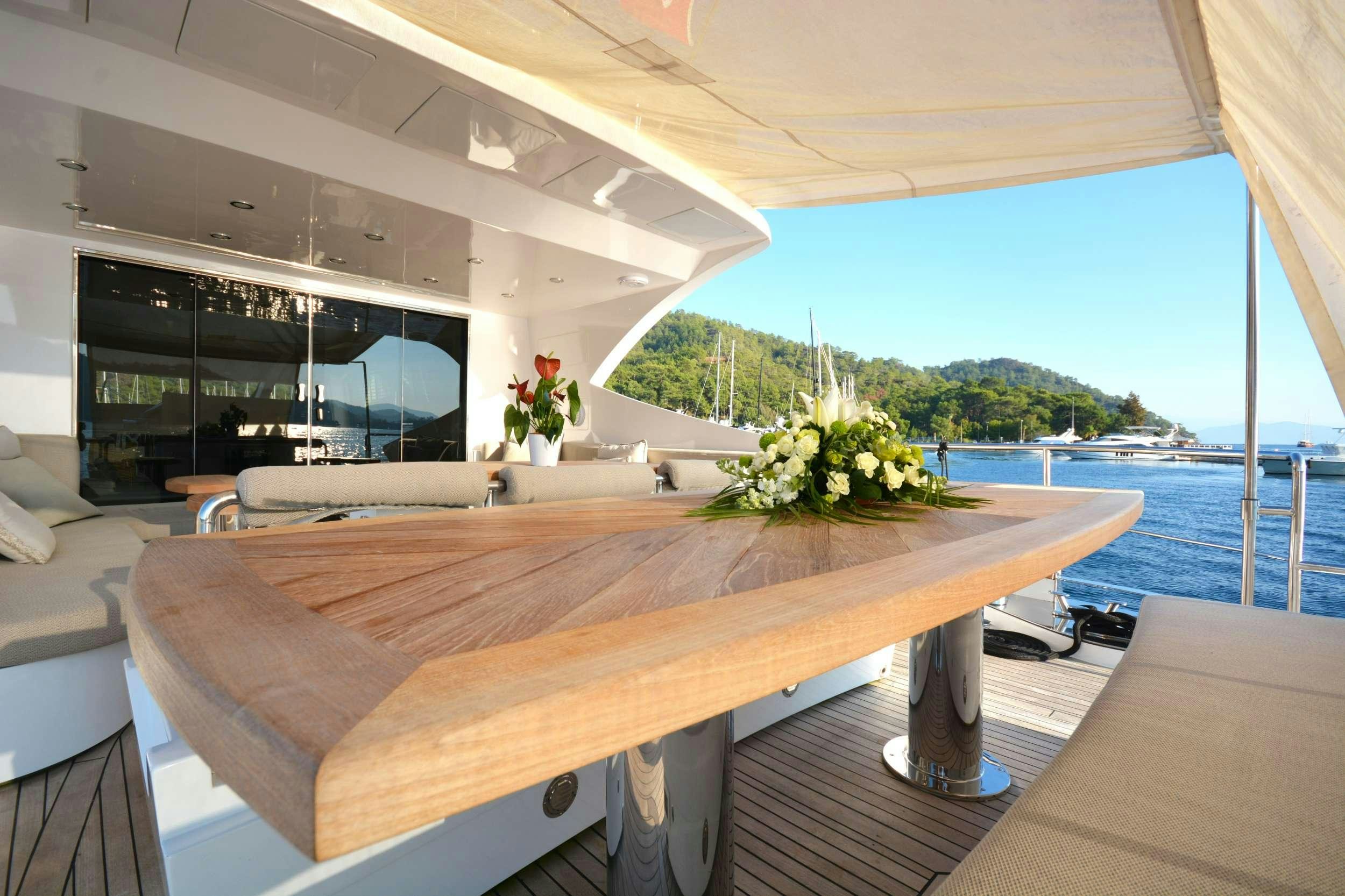 a table with a bench aboard GOLDFINGER Yacht for Charter