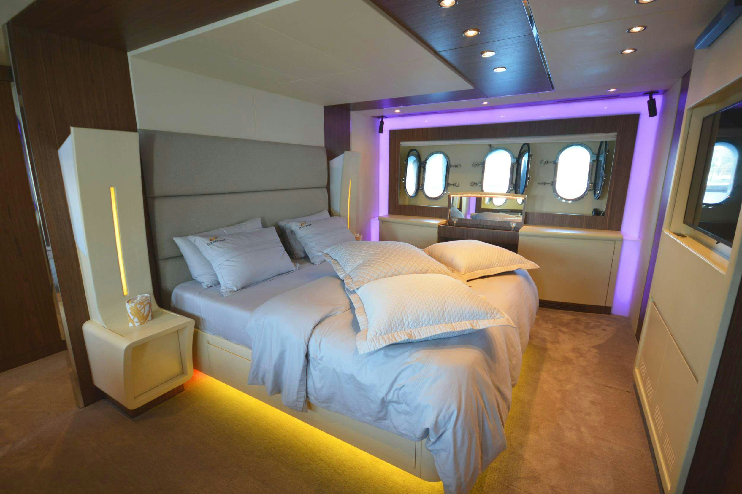 a room with a bed and a mirror aboard GOLDFINGER Yacht for Charter