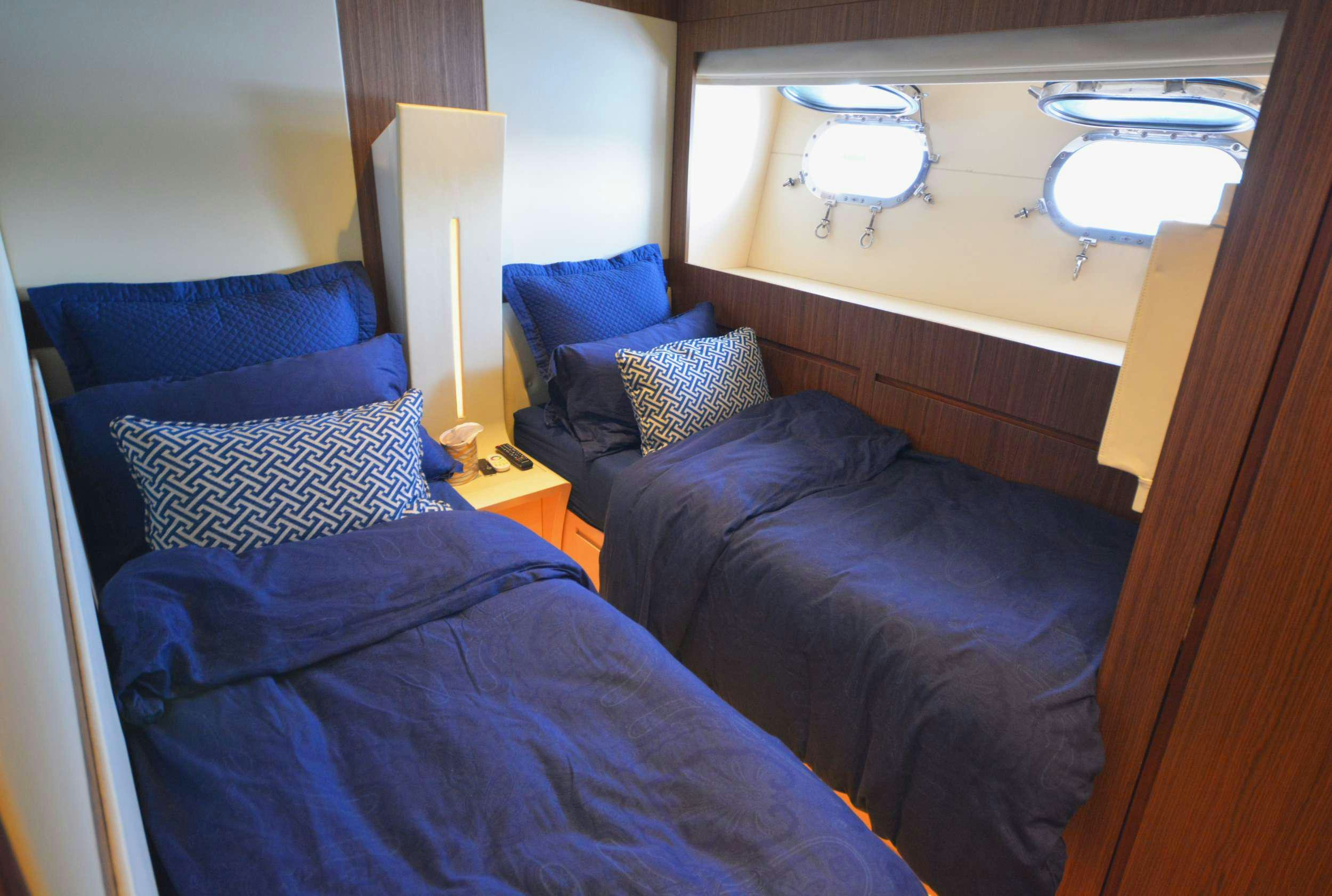 a couple of beds in a room aboard GOLDFINGER Yacht for Charter