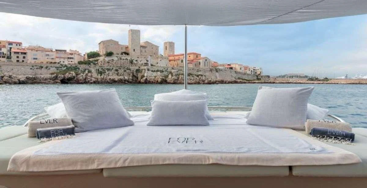 a white bed with pillows on it aboard FOR EVER Yacht for Charter