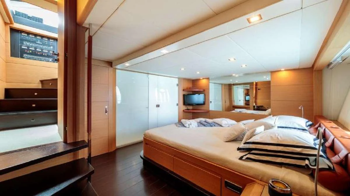 a room with a bed and a television aboard FOR EVER Yacht for Charter