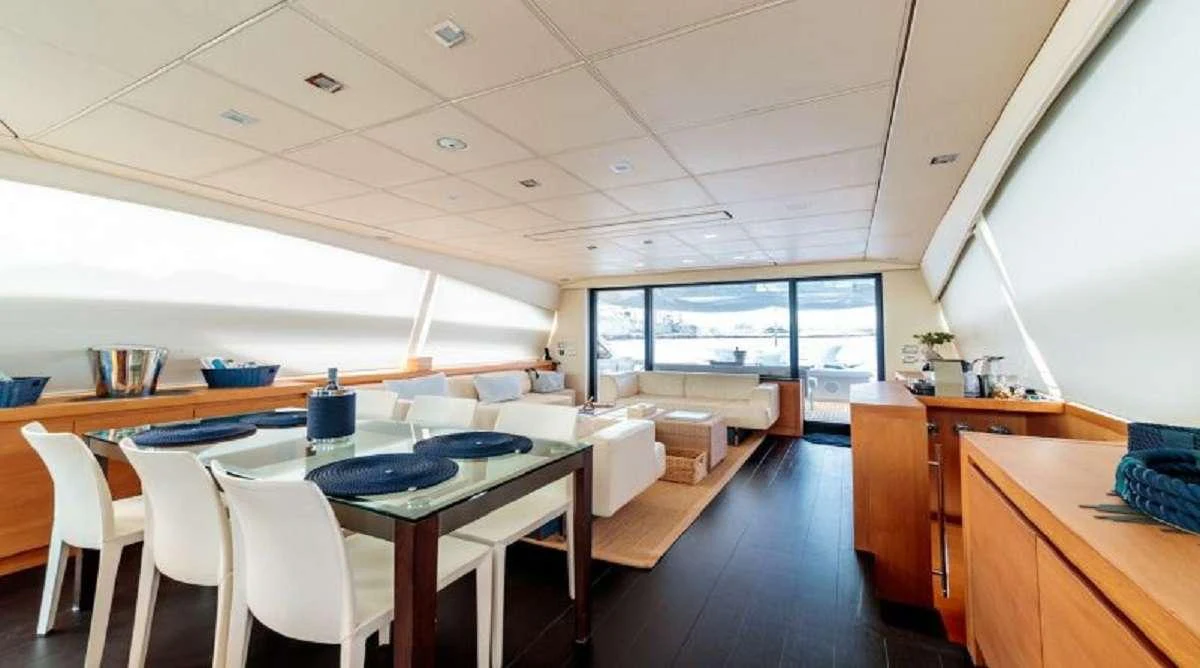 a room with tables and chairs aboard FOR EVER Yacht for Charter